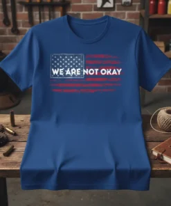 Blue t-shirt with distressed American flag graphic and "WE ARE NOT OKAY" text in white