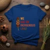We Are On Indigenous Land t-shirt with feather graphic and colorful text in orange, red, and brown