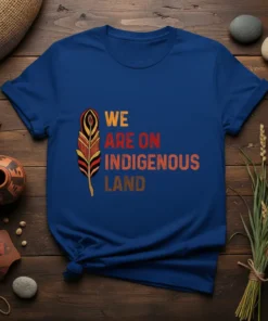 We Are On Indigenous Land t-shirt with feather graphic and colorful text in orange, red, and brown