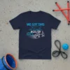 Navy t-shirt with "WE GOT THIS AGILITY" text, a jumping dog silhouette, agility tunnel, and jump bar graphic