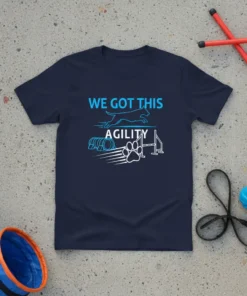 Navy t-shirt with "WE GOT THIS AGILITY" text, a jumping dog silhouette, agility tunnel, and jump bar graphic
