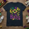 We Got The Baby text with Mardi Gras colors and baby-themed graphics on a navy t-shirt