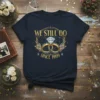 Navy blue t-shirt with "We Still Do Since 1999" text, wedding rings, and diamond graphic