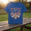 We the People Like To PARTY text with American flag rockets and eagle graphic on a blue t-shirt
