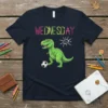 Wednesday Dinosaur Soccer T-Shirt design featuring a green T-Rex kicking a soccer ball, with colorful "WEDNESDAY" text and a smiling