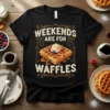Weekends Are For Waffles quote with a graphic of syrup-covered waffles topped with whipped cream and berries on a black