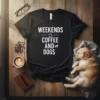 Black t-shirt with white text "Weekends Coffee And Dogs" and small coffee cup and dog icons