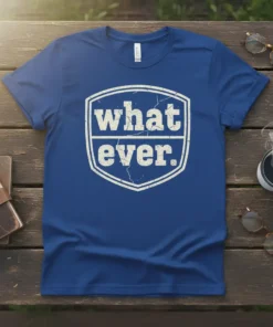 Blue t-shirt with distressed white text "what. ever." inside a shield shape, expressing a sarcastic attitude
