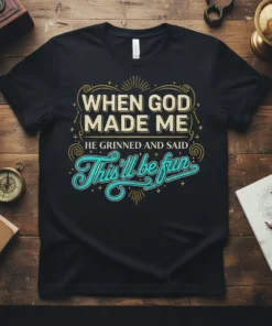 Black t-shirt with the quote "When God Made Me He Grinned And Said This'll Be Fun" in vintage-inspired typography