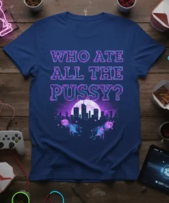 T-shirt with neon text "WHO ATE ALL THE PUSSY?" above a pixelated retro cityscape and moon