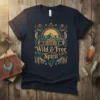 Navy t-shirt featuring the "Wild & Free Spirit" quote with a boho mountain landscape design, feathers, and cacti