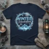 Winter Wonderland text with snowflake circle and icy mountains graphic on a navy t-shirt