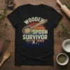 Wooden Spoon Survivor text with a vintage sunset graphic and a wooden spoon illustration on a black t-shirt