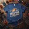 T-shirt with "World's Most Awesome Glass Blower" text and a graphic of a blowpipe and sun