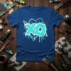 Blue t-shirt with large aqua "XO" graphic, surrounded by hearts and splattered paint effect