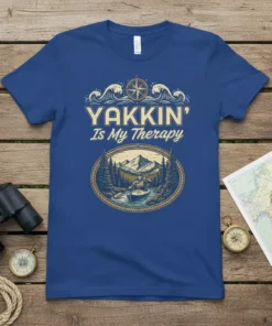 Yakkin' Is My Therapy t-shirt design featuring a kayaker in a scenic mountain river landscape, surrounded by trees and waves