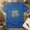 Blue t-shirt with gold glitter "YAY GOD!" text and a dove graphic, surrounded by starburst design