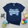 Navy blue t-shirt with "YAY, IT'S COLONOSCOPY DAY!" in colorful text and cartoon intestines graphic