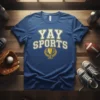 Blue t-shirt with "YAY SPORTS" in white and gold lettering, featuring a golden trophy and laurel wreath graphic