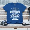 Yes I Do Have A Retirement Plan I Plan On Skiing text design on a blue t-shirt with mountain graphic