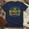 Navy t-shirt with yellow text "YO NO CREO EN Fronteras" inside a graphic resembling a broken brick wall and a
