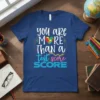 Autism awareness t-shirt with text "you are MORE Than a test score SCORE" and a colorful puzzle heart graphic