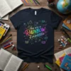T-shirt with "You are a Rainbow of Possibilities" text in colorful gradient, surrounded by educational icons like books, apples, and