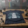 T-shirt with white text "YOU CAN'T BAN THESE GUNS" and graphics of muscular arms and dumbbells