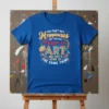 You Can't Buy Happiness But You Can Major in Art quote on a blue t-shirt with art supplies graphic