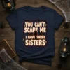 Halloween t-shirt featuring "You Can't Scare Me I Have Three Sisters" text with spooky graphics and a distressed border