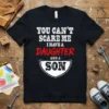 Black t-shirt with white and red text reading "YOU CAN'T SCARE ME I HAVE A DAUGHTER AND A SON"