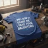Blue t-shirt with white text reading "YOU DON'T SCARE ME I HAVE FOUR DAUGHTERS" and wrench graphics, perfect for dads