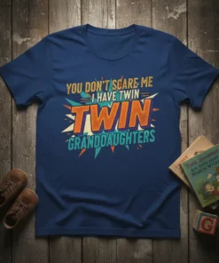You Don't Scare Me I Have Twin Granddaughters text design on a navy blue t-shirt with vibrant orange, yellow, and