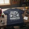 T-shirt with "You Don't Scare Me I Have Two Daughters" text and mythical creature graphics