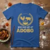 You Had Me At Adobo T-Shirt with rooster and pig graphics above a bowl of food