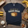 Navy blue t-shirt with text "you had me at BANANA BREAD" and a cartoon illustration of a loaf of banana