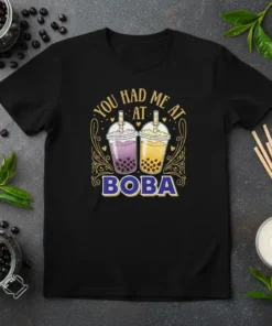 Black t-shirt with "You Had Me At Boba" text and two cartoon bubble tea cups, one purple and one yellow