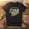Black t-shirt with "You Had Me At Corn Sweat" text and corn graphics, featuring Iowa flag detail