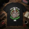 Skeleton holding a book with "You Had Me At Trigger Warning" text, on a black t-shirt, gothic design