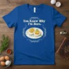 Blue t-shirt with "You Know Why I'm Here." text above a graphic of two deviled eggs in a decorative frame