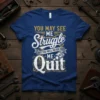 You May See Me Struggle But You Will Never See Me Quit quote on a blue t-shirt with distressed typography