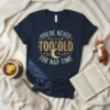 Navy t-shirt with "You're Never Too Old For Nap Time" quote in gold and white lettering, featuring a crescent moon