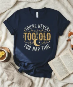 Navy t-shirt with "You're Never Too Old For Nap Time" quote in gold and white lettering, featuring a crescent moon