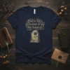 Navy t-shirt with gold text "You're not invited to my funeral" and a tombstone with a rose graphic