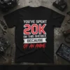 Black t-shirt with "You've Spent 20K On This Shitbox Because Of An Anime" quote in bold red and white typography