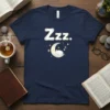 Zzz. text and cute sleeping moon with stars graphic on a navy blue t-shirt