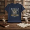 Dark navy t-shirt featuring the #FREEPRESS hashtag and a stylized phoenix graphic, symbolizing freedom and resilience