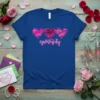 Blue t-shirt with the text "#galentines day" in pink neon script and three abstract hearts above it