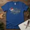Royal blue t-shirt with a vintage-style design featuring a Santa hat and holly sprigs around the text "#humbug"